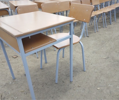 A durable school desk and chair set featuring a built-in storage shelf, sturdy metal frame, and spacious writing surface. Ideal for classrooms, schools, and educational institutions.