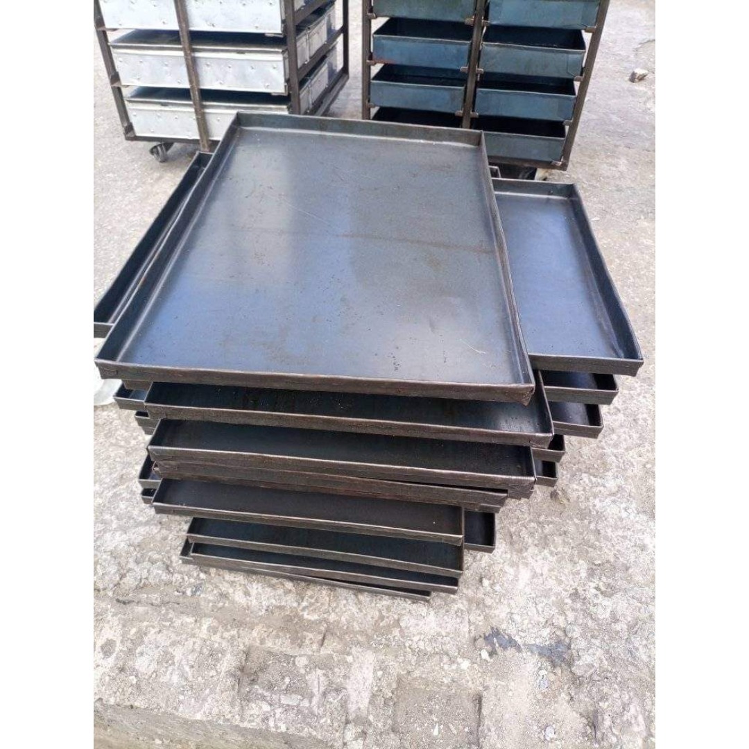 A heavy-duty, industrial metal baking tray featuring raised raised edges for secure handling. Ideal for baking, roasting, and cooling goods in high-volume commercial kitchens and bakeries.