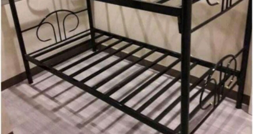 A space-saving, heavy-duty twin-over-twin metal bunk bed frame with built-in metal mattress slats and ornamental arched headboards. Ideal for hostels, dormitories, and shared bedrooms.