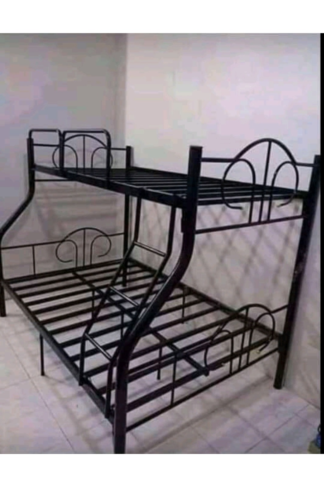 A versatile, space-saving metal bunk bed frame featuring a twin-size top bunk over a double-size bottom bed. Includes built-in safety guardrails, a secure center ladder, and ornamental arched accents.